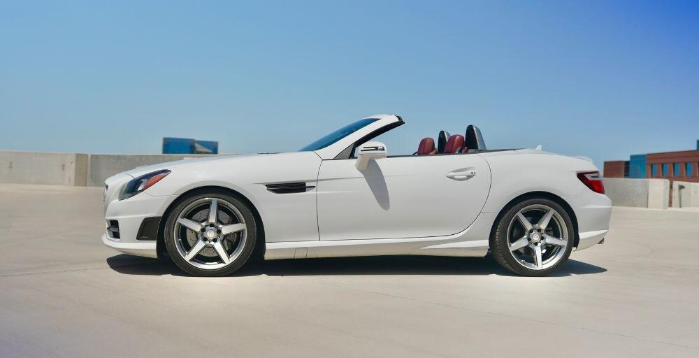 Wide angle side shot of the Mercedes-Benz SLK-Class vehicle with a blue sky background