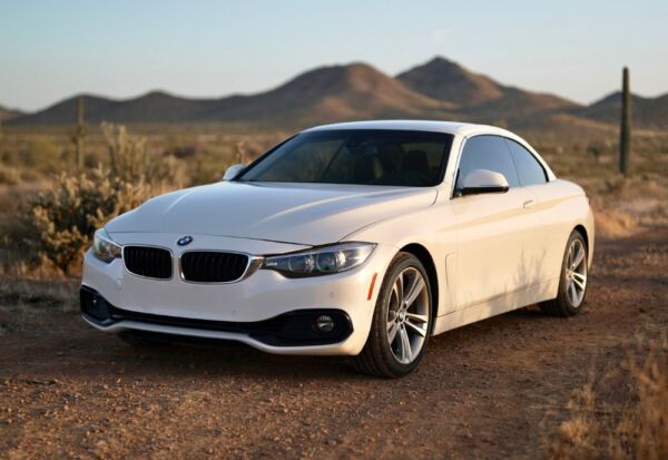 Frontal angled shot of the BMW 4-Series Convertible with mountains in the background.
