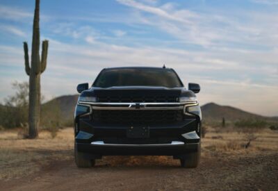 Frontal shot of the Chevrolet Suburban with mountains in the background.