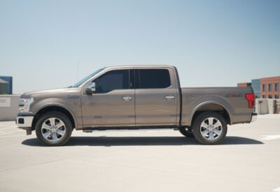 Medium wide shot of the Ford F-150 with the vehicle facing left and a blue sky background