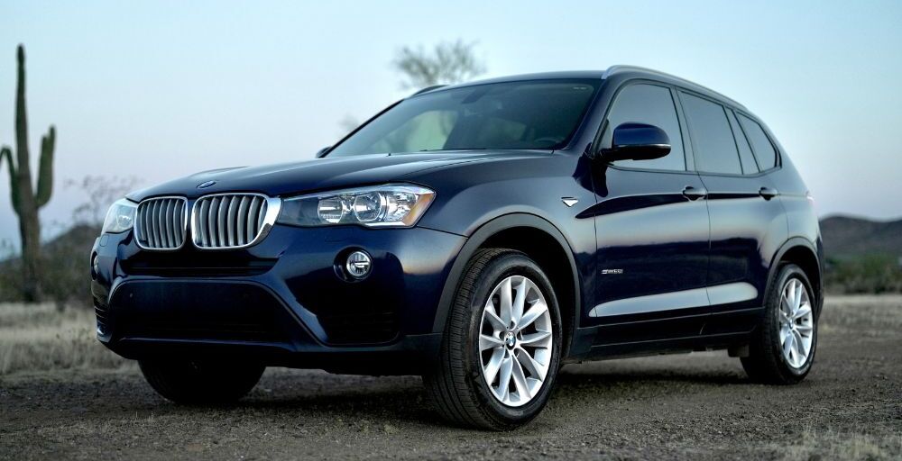 BMW X3 facing left in a medium wide shot.