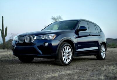 BMW X3 facing left in a medium wide shot.