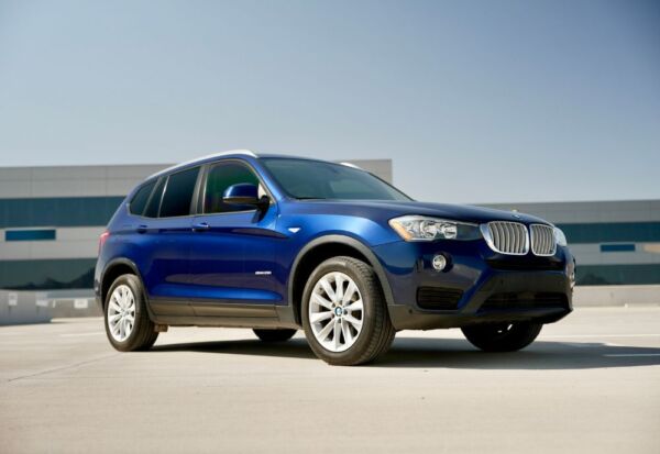 Medium wide shot of the BMW X3 facing right.