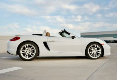 wide side shot of the Porsche Boxster facing right with a blue sky background