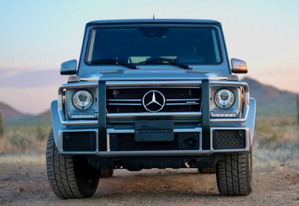 Front head on shot of the Mercedes Benz G-Wagon with a blue sky background