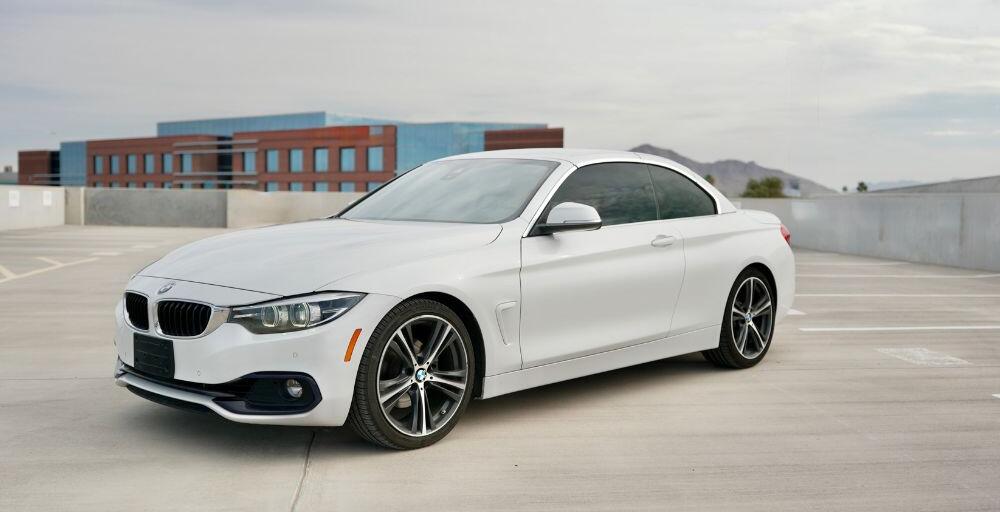 A BMW 4-Series Convertible in a wide shot facing left.