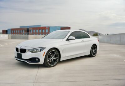 A BMW 4-Series Convertible in a wide shot facing left.