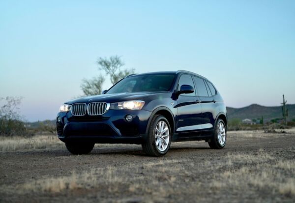 Medium wide shot of the BMW X3 facing left at dusk.