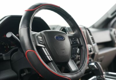 Interior shot of the Ford F-150 showcasing the driver's side steering wheel area