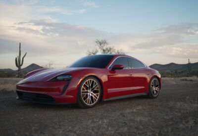 front angle shot of the Porsche Taycan tilted and at dusk