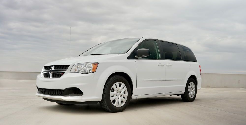Frontal angled shot of the Dodge Grand Caravan with blue sky in the background