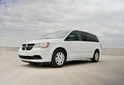 Frontal angled shot of the Dodge Grand Caravan with blue sky in the background