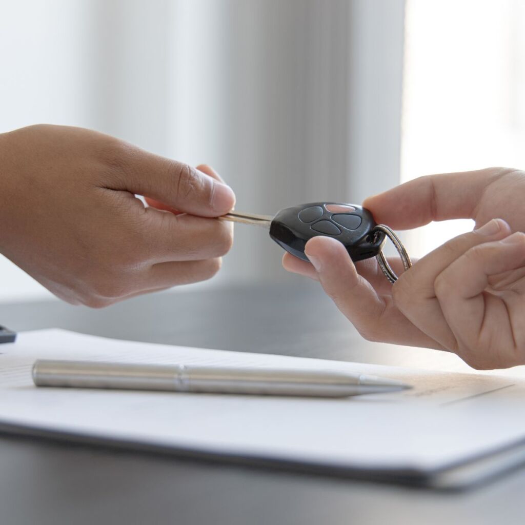 Keys are handed to the renter of a luxury car.